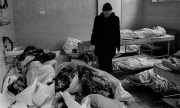 A dead teenage girl is carried into the morgue at Sarajevo's Kosevo hospital on December 6, 1993.