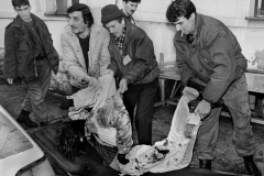 A dead teenage girl is carried into the morgue at Sarajevo's Kosevo hospital on December 6, 1993.
